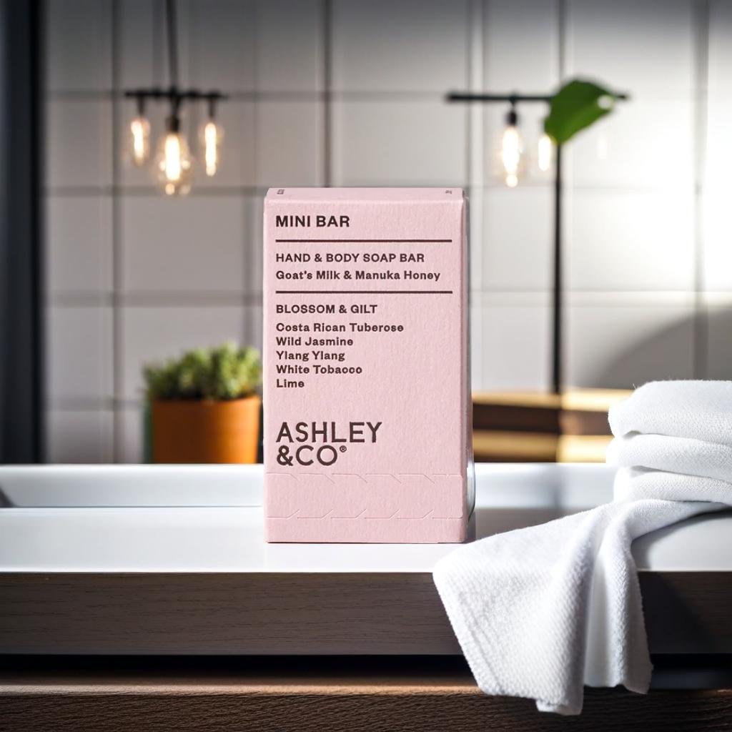 A product standing on a bathroom countertop, beside a white towel