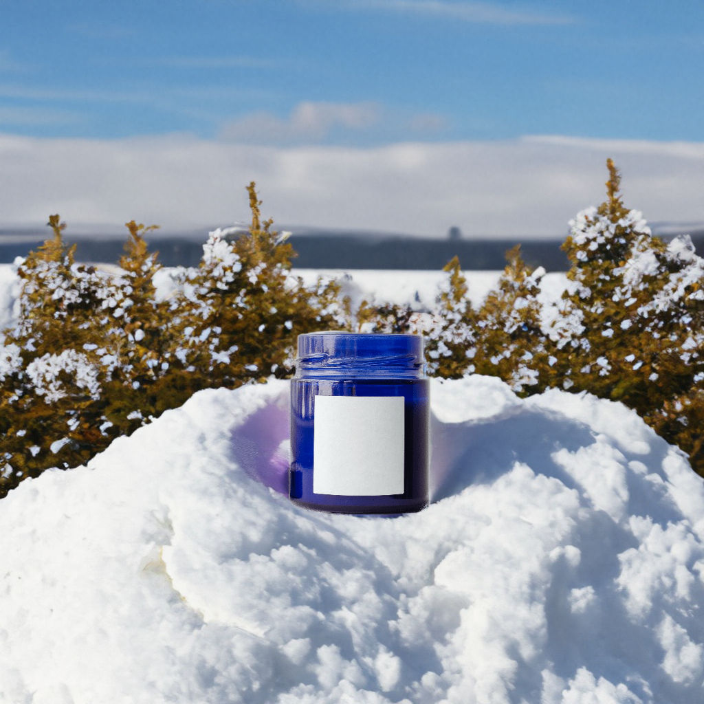 A candle on a snowy field, under the night sky