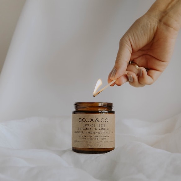 A hand lighting a candle