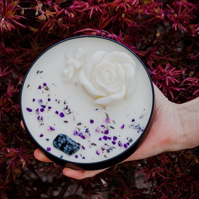 The topdown view of a candle with petals