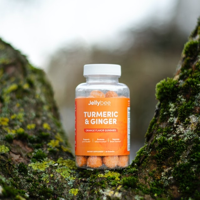 A bottle of supplement on a moss-filled tree trunk