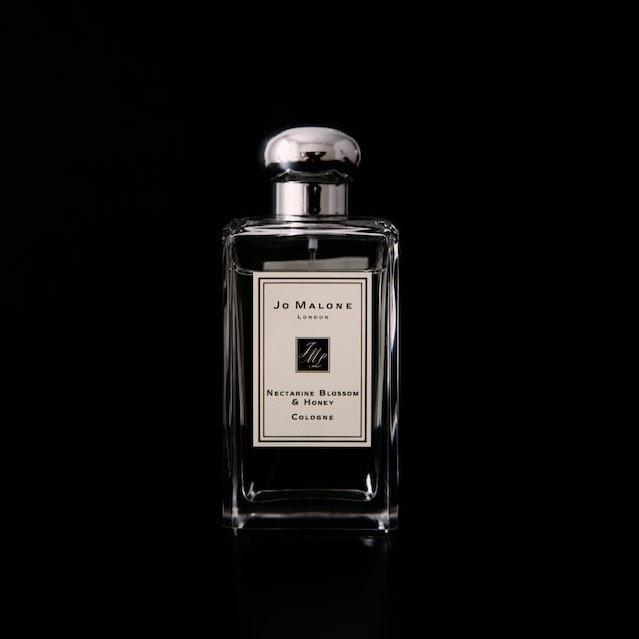 A photo of a Jo Malone cologne in a black backdrop